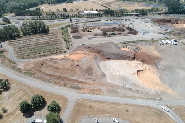 An aerial view of Lakeside Industries' stockyard for mulch and soil products showing piles of stock. 